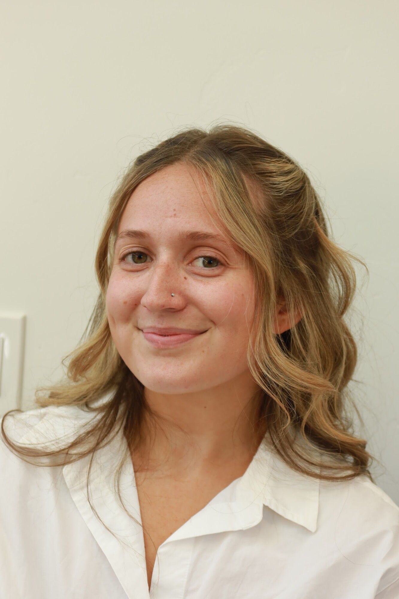 Before: a blonde woman in a white shirt with bare skin and hair down