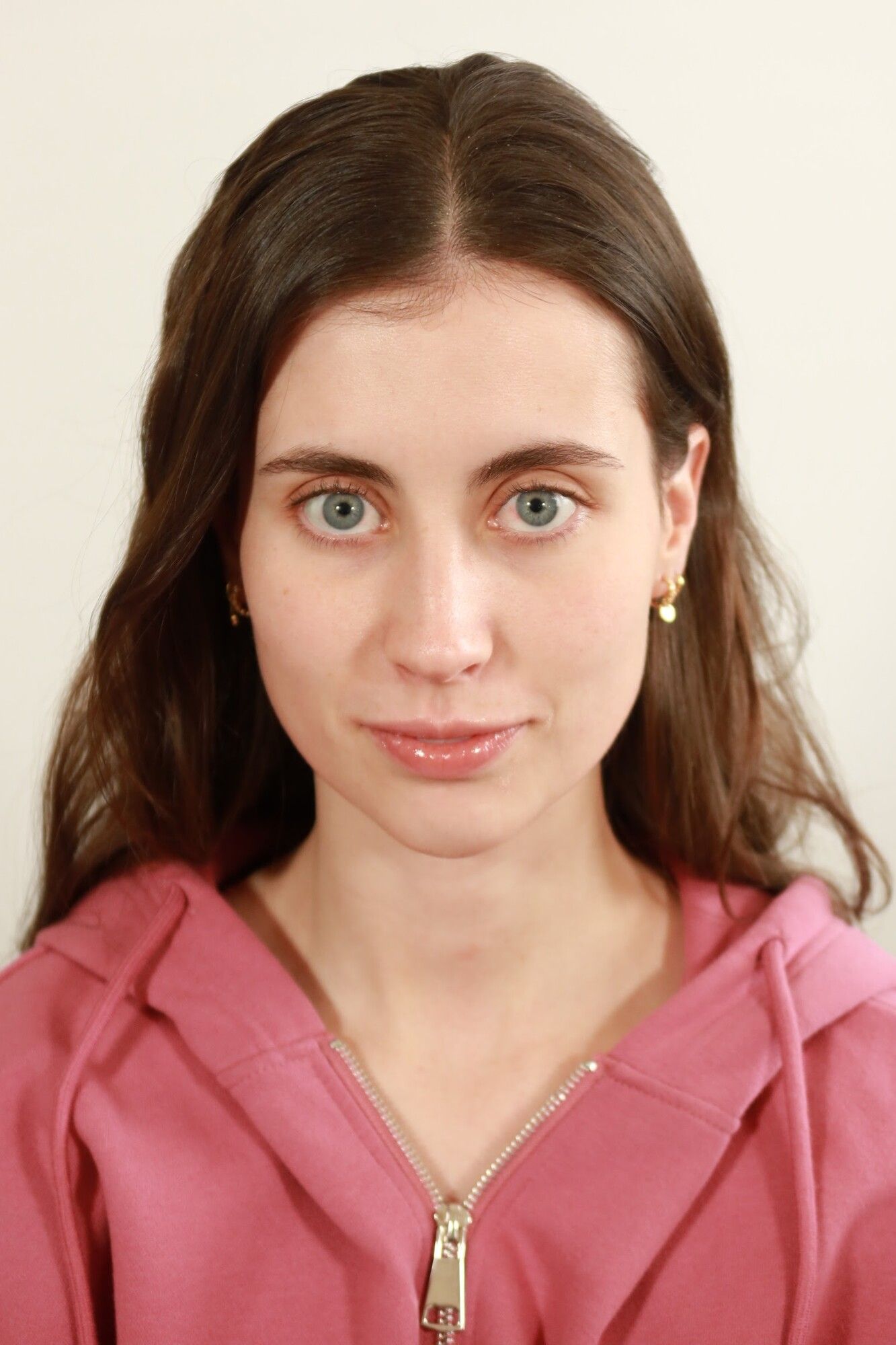 Before: a brunette woman in a pink hoodie with bare skin and hair down